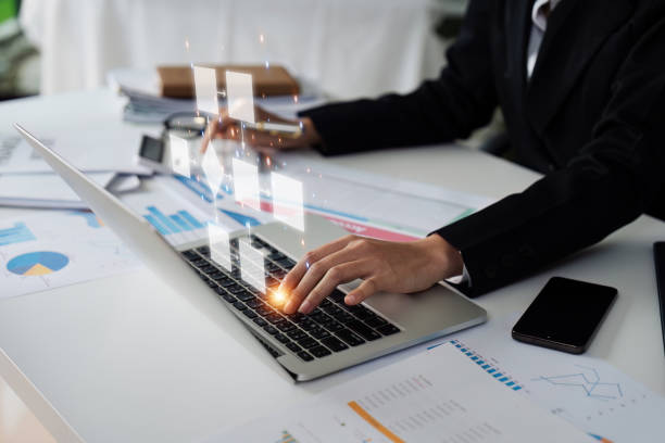 Businessman using a computer analysis for process and workflow automation with flowchart Businessman using a computer analysis for process and workflow automation with flowchart process automation office stock pictures, royalty-free photos & images