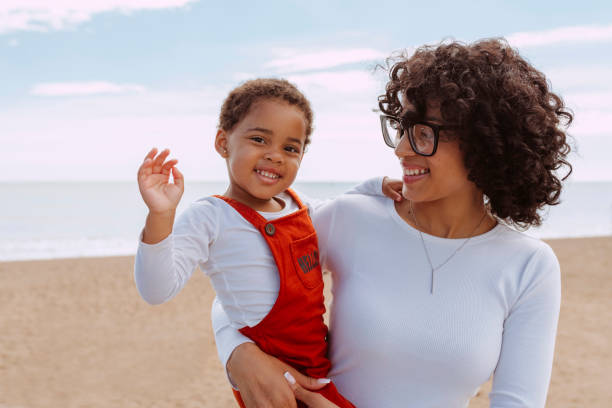 istock Mother with her daughter enjoying at beach 2132483963