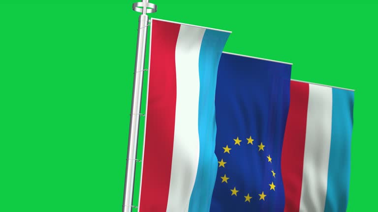 The flags of Luxembourg and the European Union waving isolated on green background