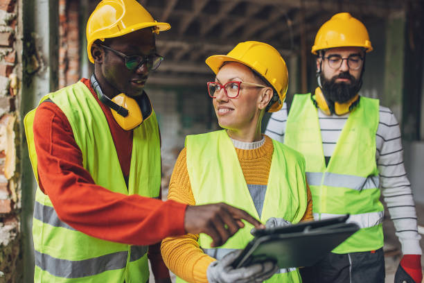 istock Diverse team of construction workers planning on site 2132515816