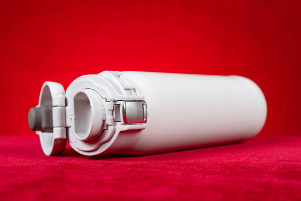 a white vacuum tumbler at horizontal composition on red