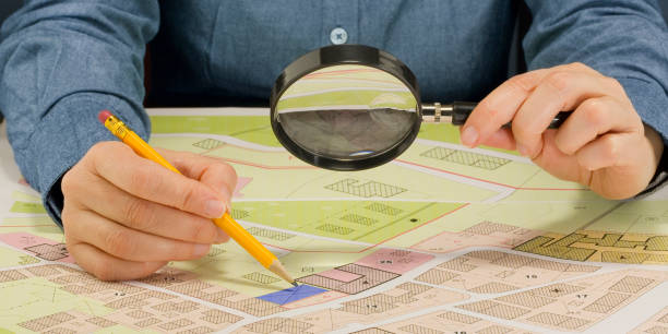 istock Buildings Permit concept with imaginary cadastral map and General Urban Plan - Building activity and construction industry concept with magnifying glass 2132540871