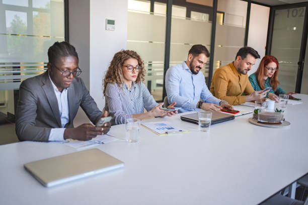 istock Business people using their mobile phones before starting corporate meeting 2132563821