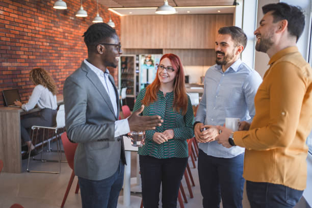 istock Multiracial business colleagues talking on a coffee break at the office 2132565645