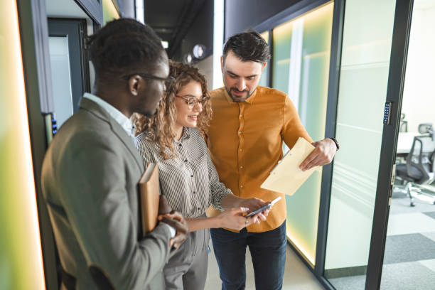 istock Three business colleagues talking about paperwork at the office 2132590888
