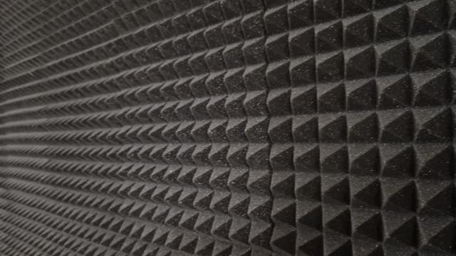 anti noise materials for door fillings and recording studios. foam with an articulated pyramid pattern. padding shattering sound waves in the apartment, theatre, red, cinema, suede, upholstery