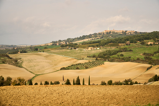 Tuscany, Italy. Autumn, hills, farmhouses, meadow fields, rolling hills and cypress trees.