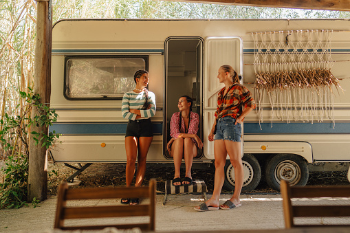 Photo of female friends enjoying a summer day in their camp