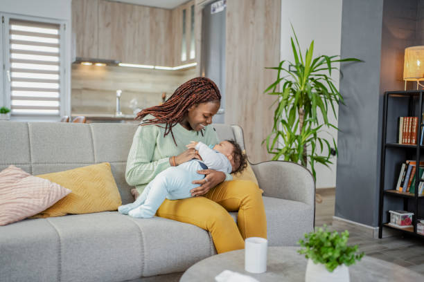 istock Black mother playing with her baby son at home 2132627640