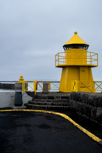A yellow watchtower in the harbor of Reykjavik, Iceland