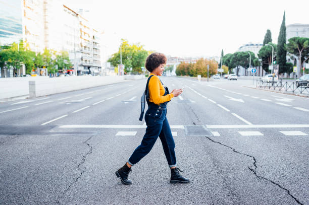 istock Young woman walking for zebra crossing 2132638602