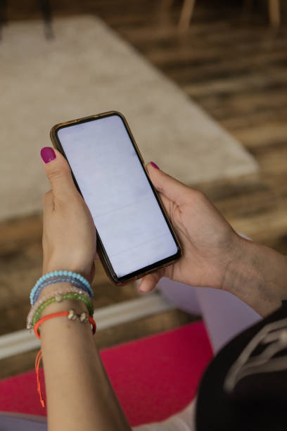 istock Internet access via digital devices at home. People and technology. Close up of woman's hands using phone with white screen. 2132642314