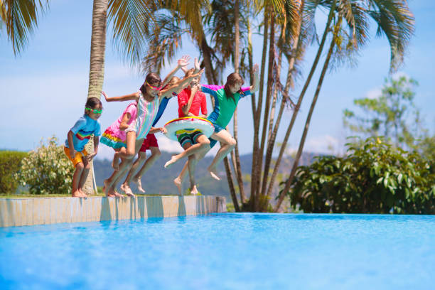 istock Kids jump into swimming pool. Summer water fun. 2132649078