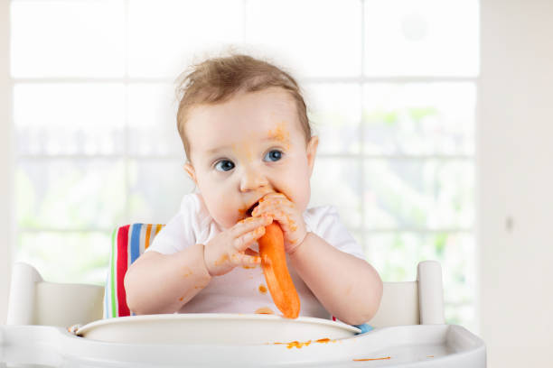 istock Baby eating vegetables. Solid food for infant. 2132659022
