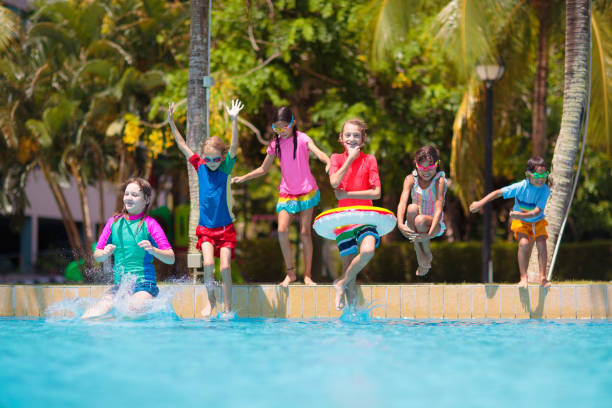 istock Kids jump into swimming pool. Summer water fun. 2132667845
