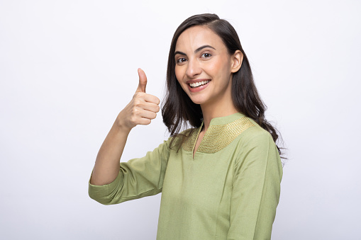 Portrait of Indian young woman wearing casual kurta on white background