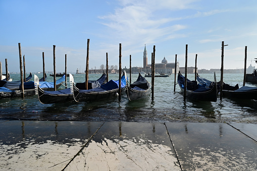 Gondolas moored with the campanile and the San Giorgio Maggiore basilica in the background