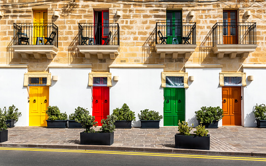 Marsaxlokk, Malta - Traditional maltese vintage house with orange, blue, yellow, red, green and brown doors and windows