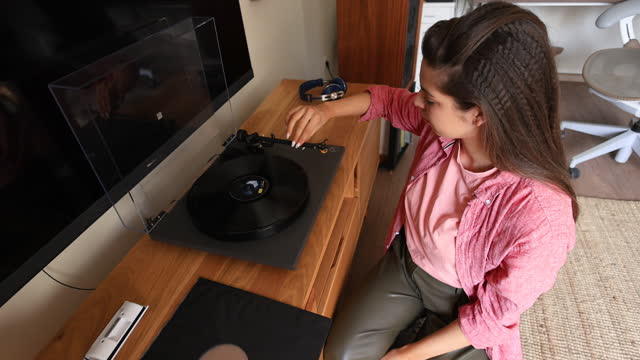 Young Woman Playing Records at Home