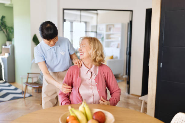 istock Caregiver assisting patient to get dressed 2132757862