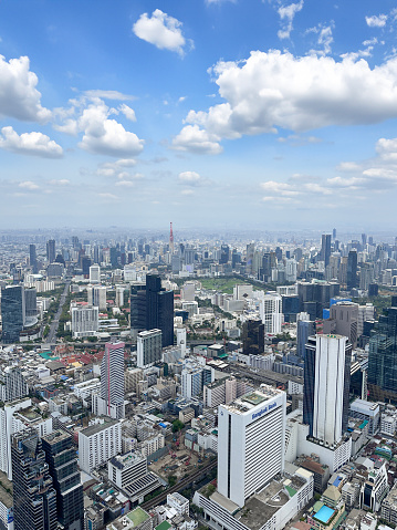 Stock photo showing elevated view of skyscrapers in Sukhumvit downtown, city centre Bangkok, Thailand seen from observation point.
