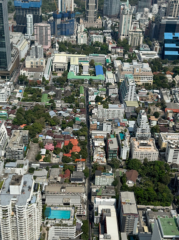 Stock photo showing close-up, elevated view of skyscrapers in Sukhumvit downtown, city centre Bangkok, Thailand seen from observation point.