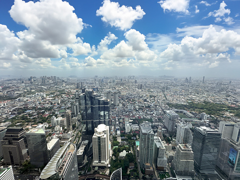 Stock photo showing elevated view of skyscrapers in Sukhumvit downtown, city centre Bangkok, Thailand seen from observation point.