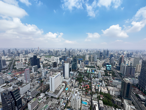 Stock photo showing elevated view of skyscrapers in Sukhumvit downtown, city centre Bangkok, Thailand seen from observation point.