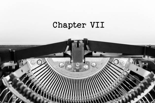 istock Chapter Seven phrase closeup being typing and centered on a sheet of paper on old vintage typewriter mechanical 2132777022