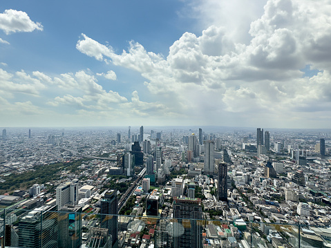 Stock photo showing elevated view of skyscrapers in Sukhumvit downtown, city centre Bangkok, Thailand seen from observation point.