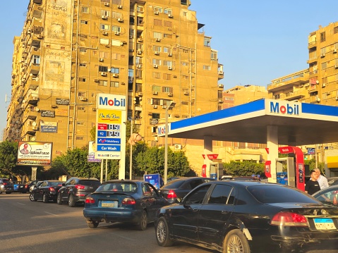 Cairo, Egypt, March 30 2024: Mobil gas and oil station, a petrol gas station of Mobil ExxonMobil corporation for global petroleum industry with Mobil1 service center, with on the run inside it, selective focus
