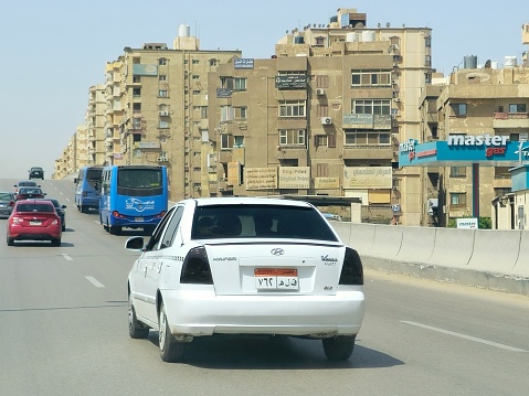 Cairo, Egypt, March 31 2024: Cairo is served by its white taxis which have been introduced in the early 2010s and aren't run by a company, but by individuals, a white Cairo Taxi In Cairo and Giza, selective focus