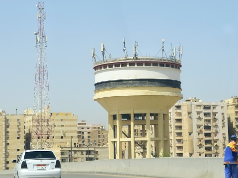 Cairo, Egypt, March 31 2024: Elevated water tank, water tower is an elevated structure supporting a water tank constructed at a height sufficient to pressurize a distribution system for potable water, selective focus