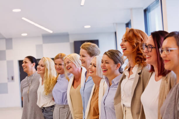 istock Smiling female colleagues standing side by side at office 2132812765
