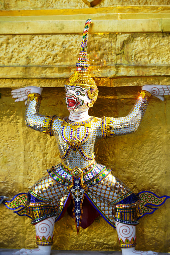 ramayana demon statue which support golden pagoda at royal grand palace,bangkok,THAILAND.