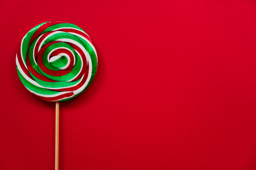 Colorful lollipop on red background
