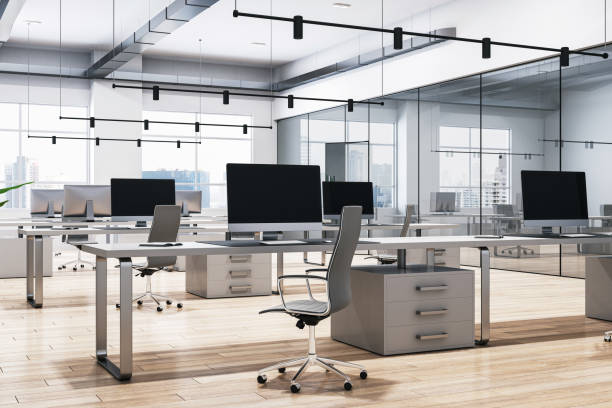 istock A modern office interior with desks, chairs, and computers, large windows in the background, and a wooden floor. 3D Rendering 2132836079