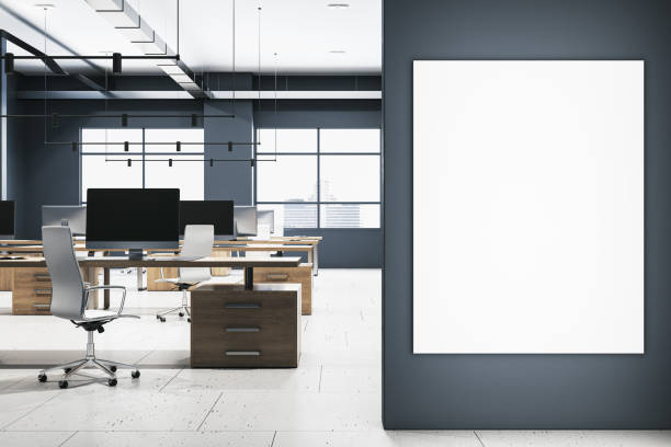 istock Modern office interior with desks, computers, and large windows, on a light wooden floor and dark walls, concept of a corporate workspace. 3D Rendering 2132838254