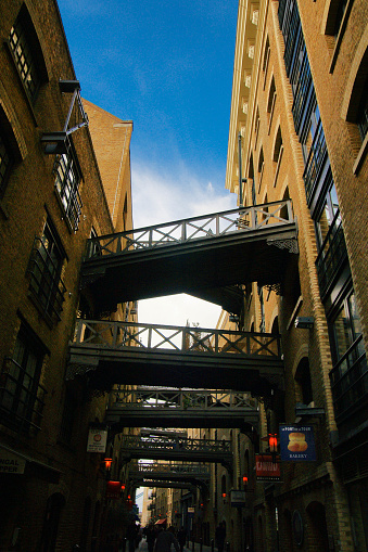 Shad Thames in London, UK. Historic Shad Thames is an old cobbled street known for its restored overhead bridges and walkways. This old street is in Bermondsey near Tower Bridge and London Bridge.
