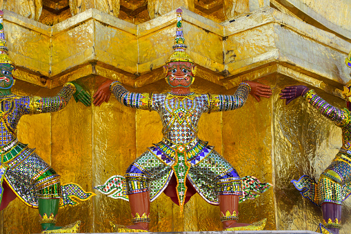 ramayana demon statue which support golden pagoda at royal grand palace,bangkok,THAILAND.
