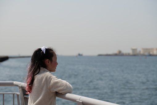 girl looking into the distance at sea