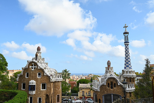 Barcelona, Spain – August 29, 2023: The unique buildings in Park Guell against the backdrop of a blue sky. Barcelona, Spain