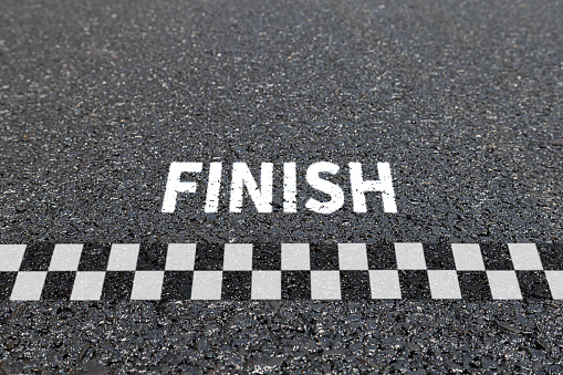 Finish line racing background top view, Textured asphalt with finishing line.