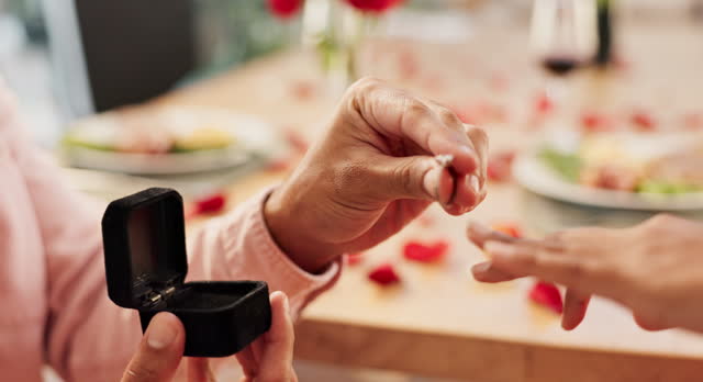 Couple, hands and proposal ring for love, marriage and celebration on valentines day or anniversary dinner. Closeup of people with jewelry for engagement finger, romance and commitment at restaurant