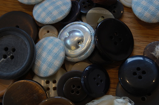 Many buttons that have been thrown on the table.