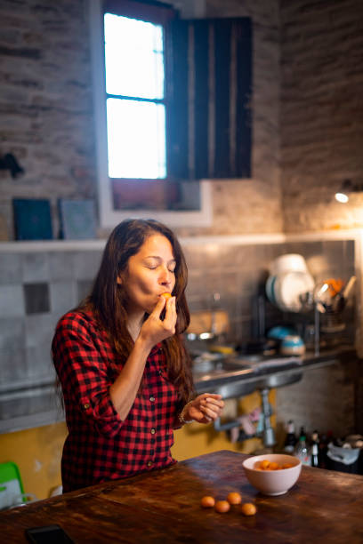 istock Woman Eating Butia Palm Fruit 2133029427