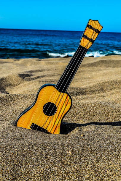 istock Guitar on the Sand Beach 2133062379