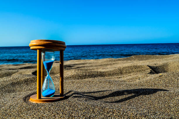 istock Hourglass Clock on the Sand Beach 2133062701