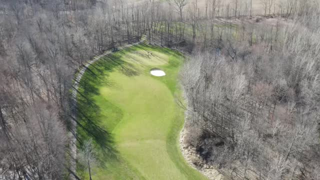 Flying over a hole on a golf course on a bright sunny day in early sping. Golf Course is Cumberland Trails Golf Club in Pataskala Ohio