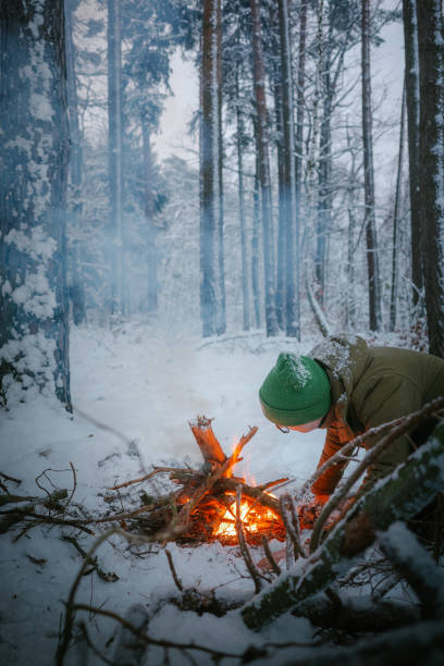 istock Winter holidays in the snow. Starting a campfire 2133079100
